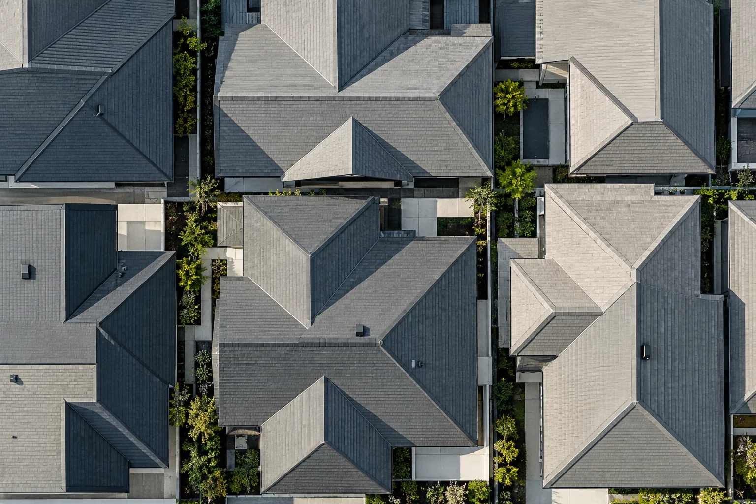 An overhead view of many rooftops fitted together into a repeating pattern