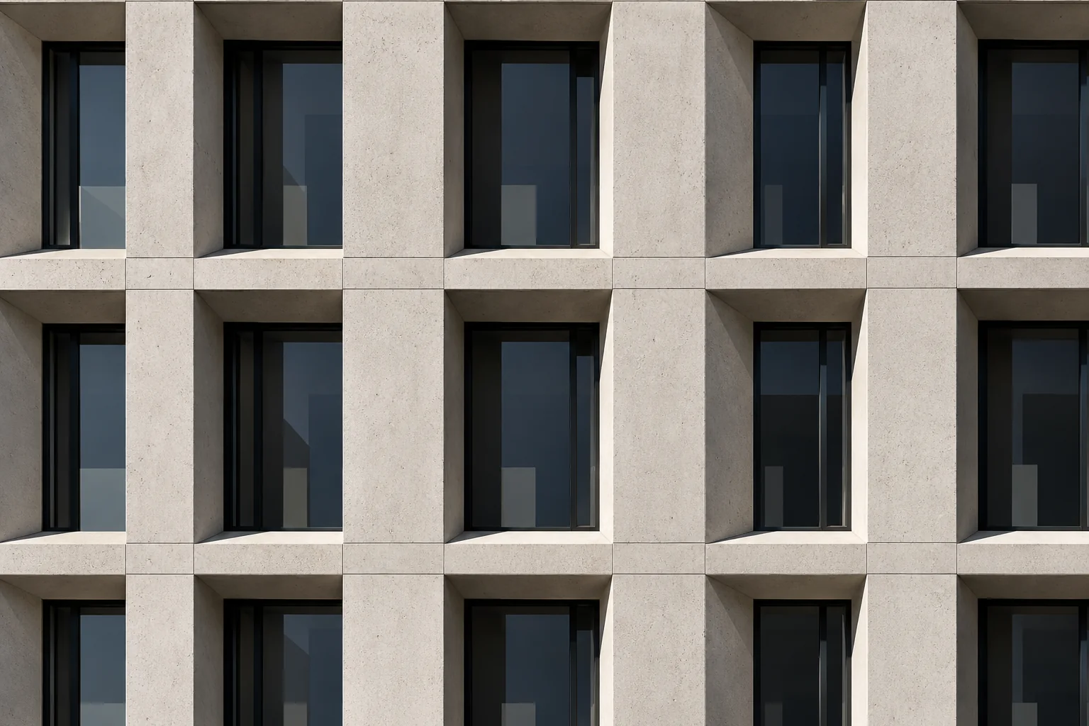 A repeating grid of identical concrete-framed windows filling the whole frame